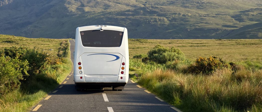 white-bus-on-scenic-road-2025-02-11-05-56-27-utc